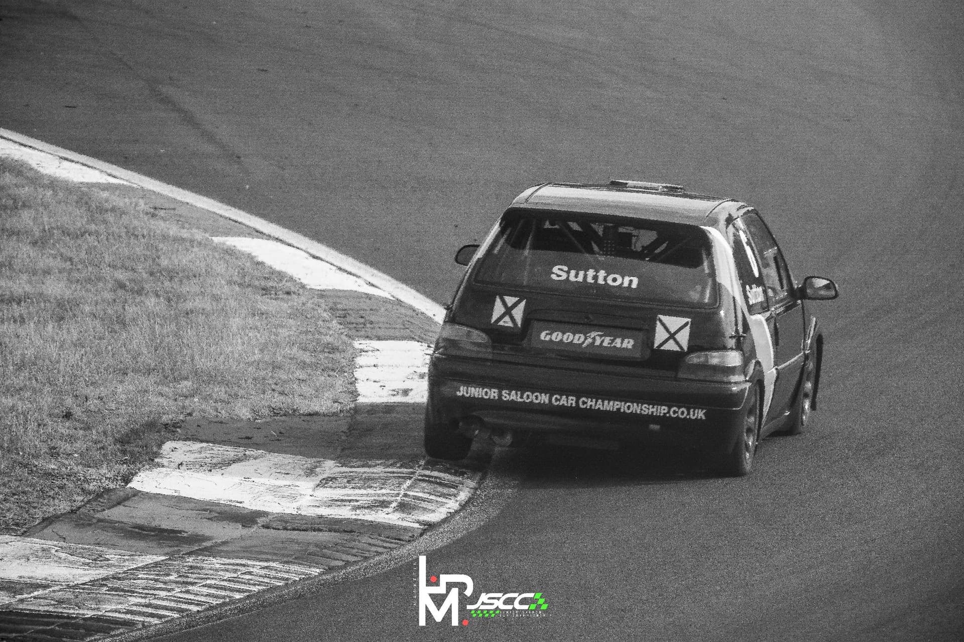 A Junior Saloon Car Championship car driving through Surtees corner at Brands Hatch